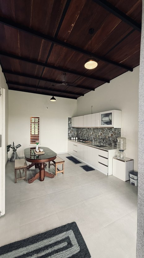 The self-catered kitchen and dining table, under a wood-beamed ceiling